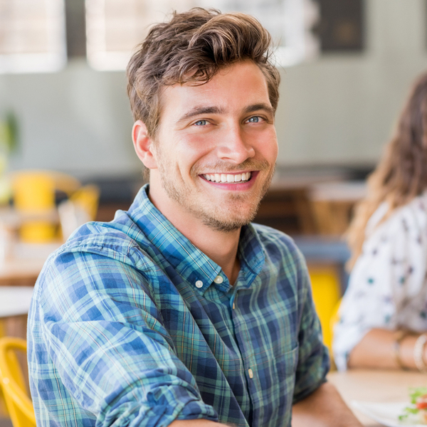 Young Man Smiling Sitting Down