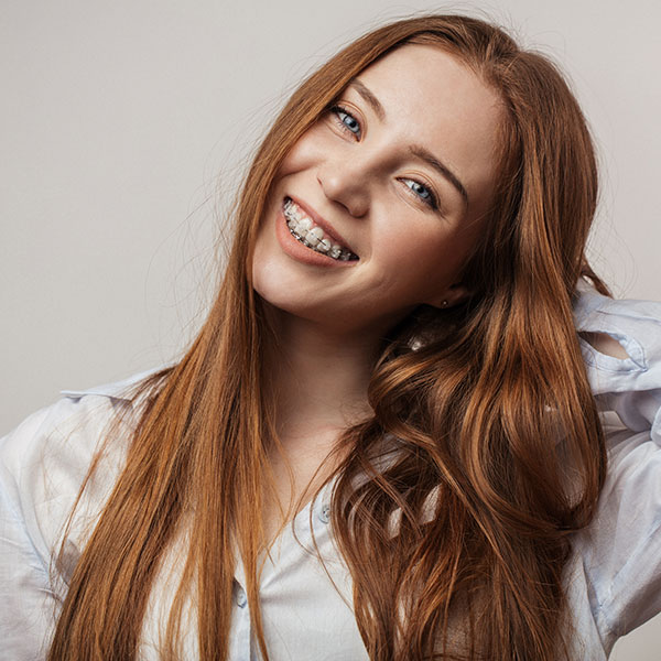 Woman in White Shirt with Six Month Smiles